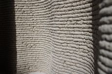 the wavy textured surface of a wall made of Corncretl, a corn based bio material alternative to concrete which has been 3D printed