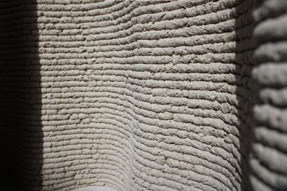 the wavy textured surface of a wall made of Corncretl, a corn based bio material alternative to concrete which has been 3D printed