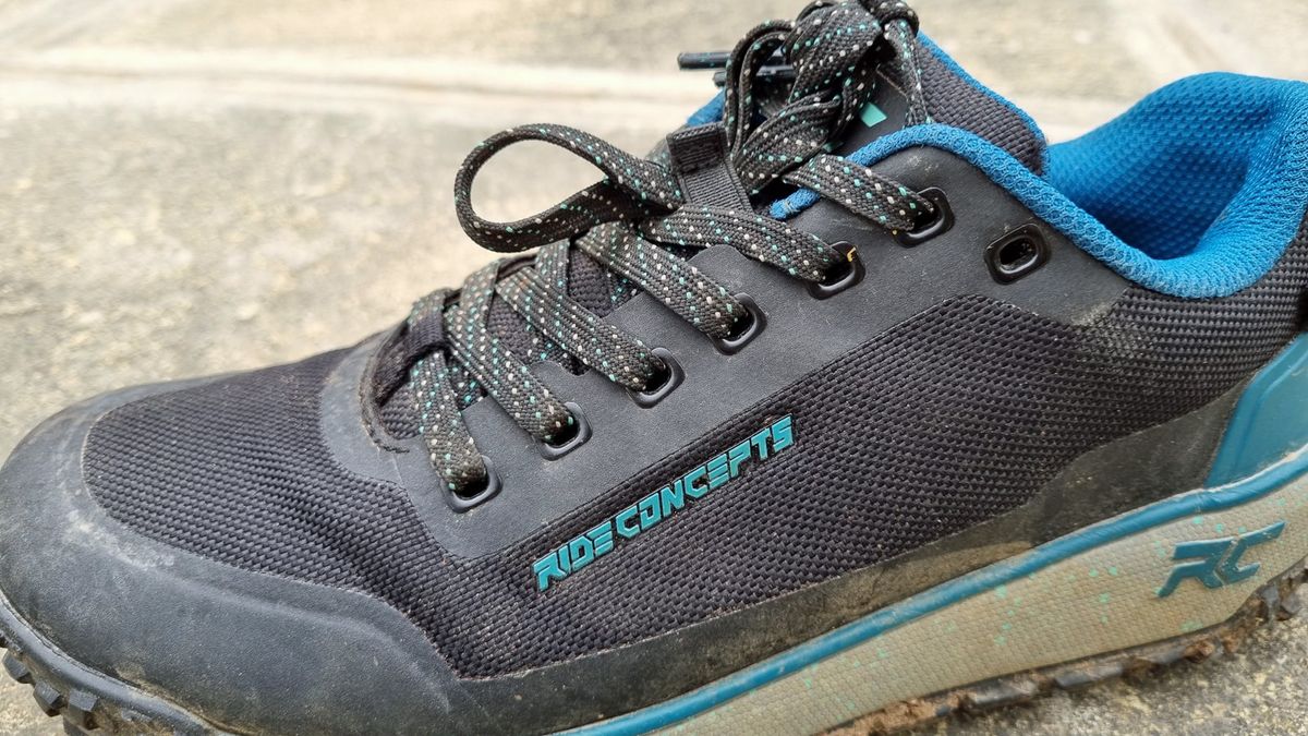 A side view of some blue Ride Concepts Flume shoes, showing the welded seamless upper