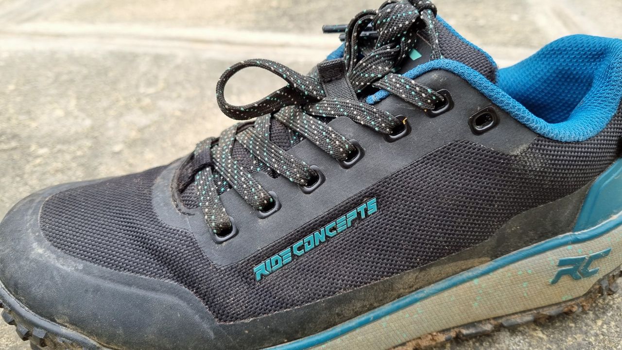 A side view of some blue Ride Concepts Flume shoes, showing the welded seamless upper