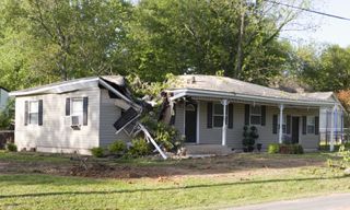 Tree damage in a home in the wake of a tornado.