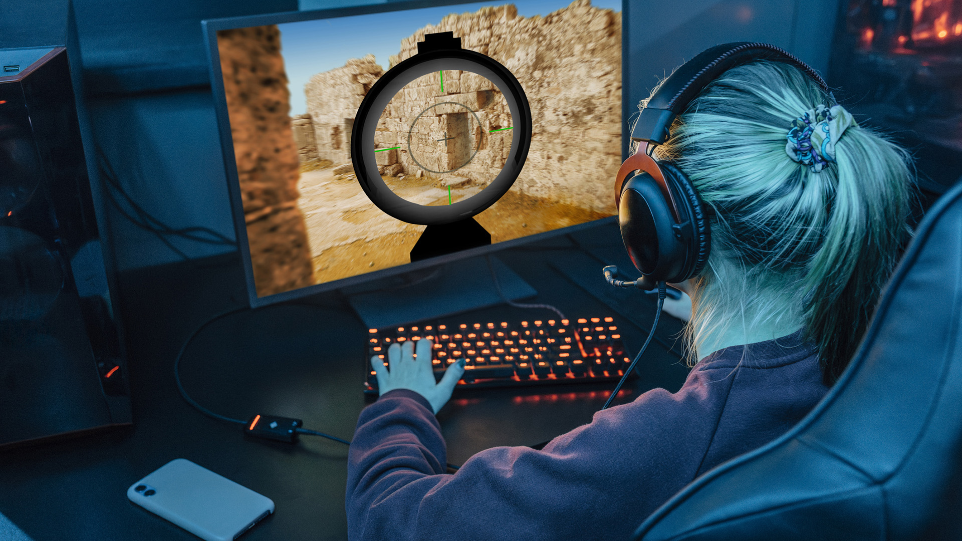 Gamer wearing headset and playing esports on desktop PC