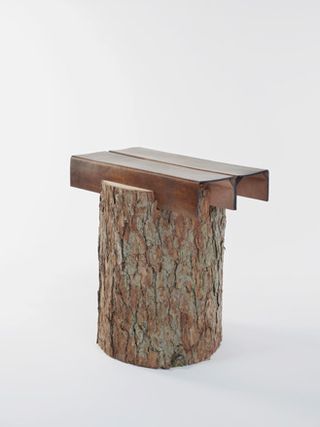 Stool with a metal tpp and timber base. Photographed against a grey background