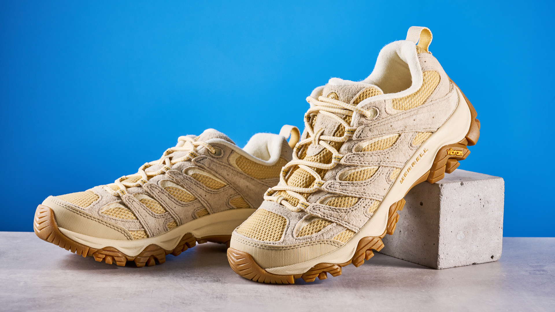 the merrell moab 3 photographed against a blue tom's guide background