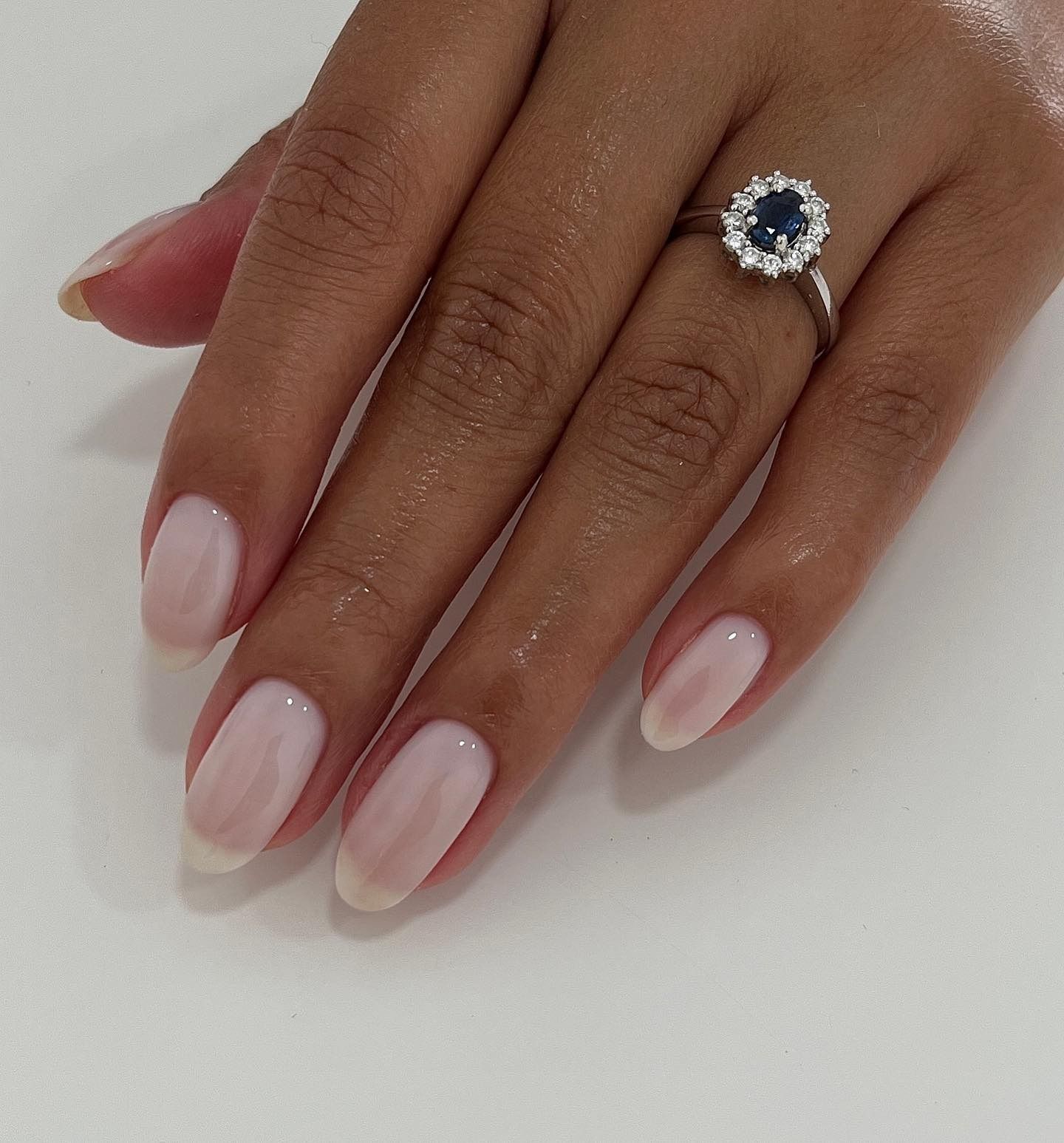 A picture of a long, almond-shaped subtle French manicure