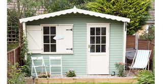 Mint green painted garden shed used as an outbuilding to highlight garden laws you could be breaking