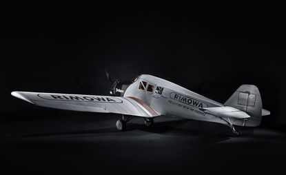 Rimowa aircraft in gray, on a black background.