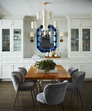 Wooden dining table, blue mirror, white cabinets