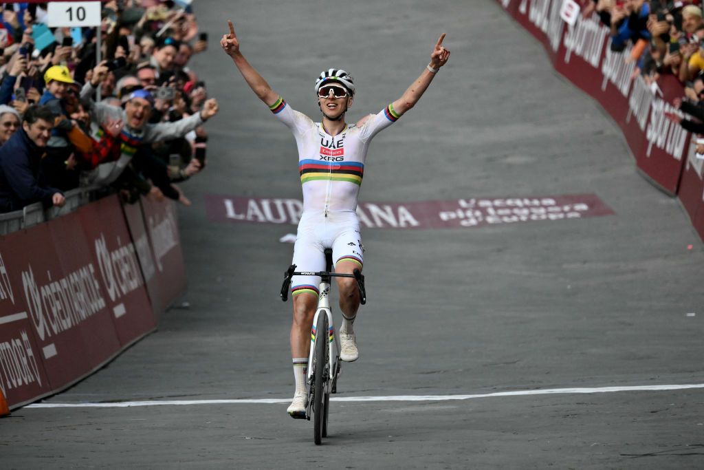 Team UAE's Slovenain rider Tadej Pogacar celebrates as he crosses the finish line to win the 19th one-day classic 'Strade Bianche' (White Roads) men's cycling race between Siena and Siena in Tuscany on March 8, 2025. (Photo by Marco BERTORELLO / AFP)