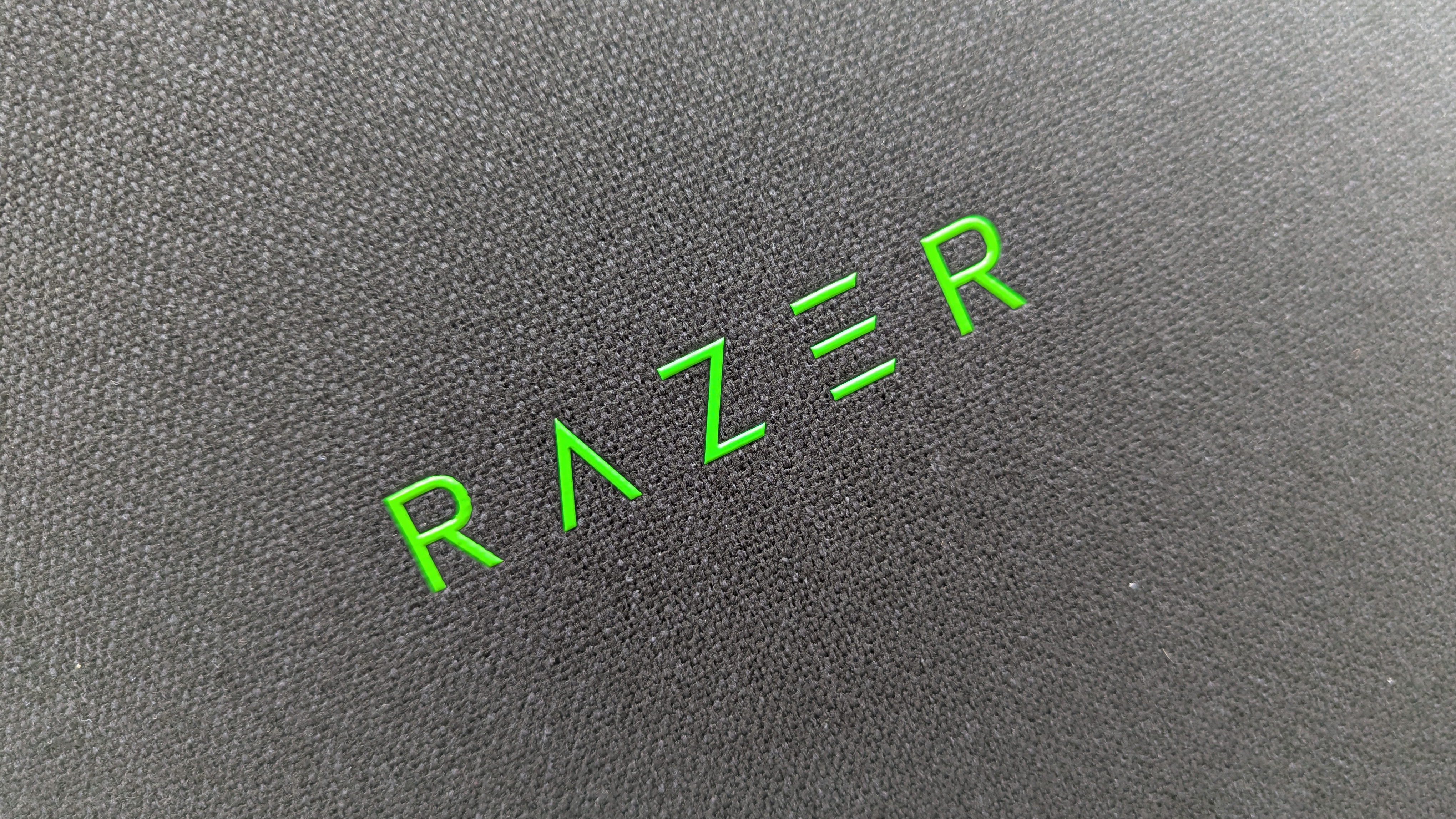 Razer Iskur V2 X gaming chair set-up outside with some Razer branded gloves!