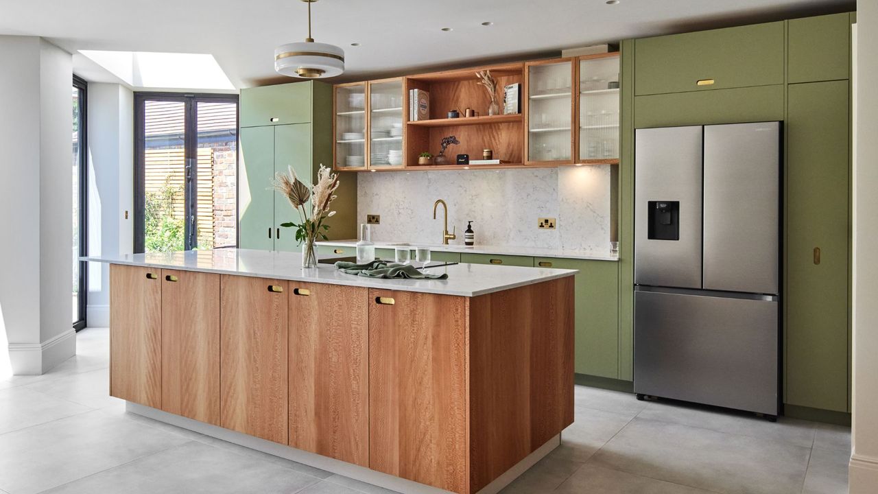 A kitchen with wooden cabinets and green features 