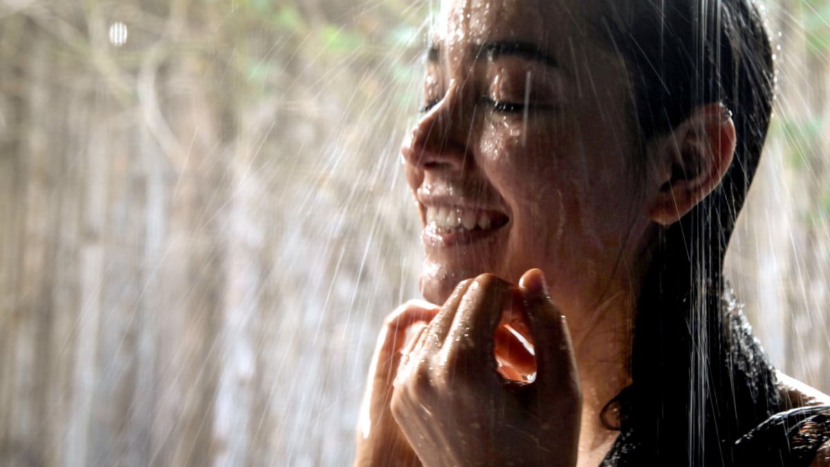 Woman taking an outdoor shower