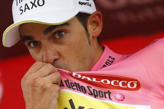 Alberto Contador kisses the maglia rosa on the stage 16 podium.