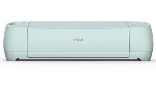 Cricut vs Silhouette; a Cricut Explore 3 cutting machine in pale green