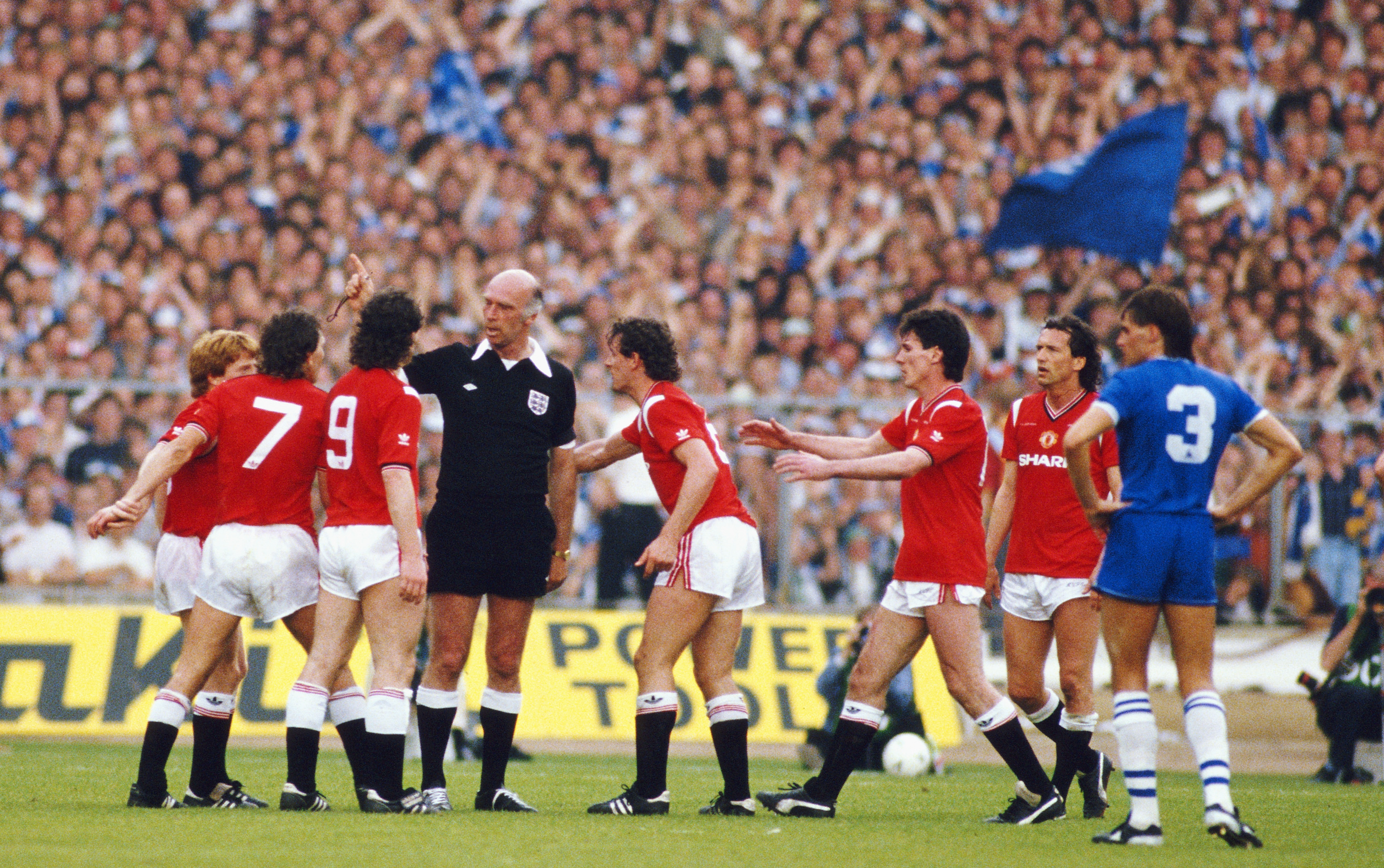 Manchester United players protest to referee Peter Willis as Kevin Moran (centre) is sent off for a foul on Peter Reid in the 1985 FA Cup final.