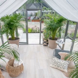 conservatory with potted plants and couch