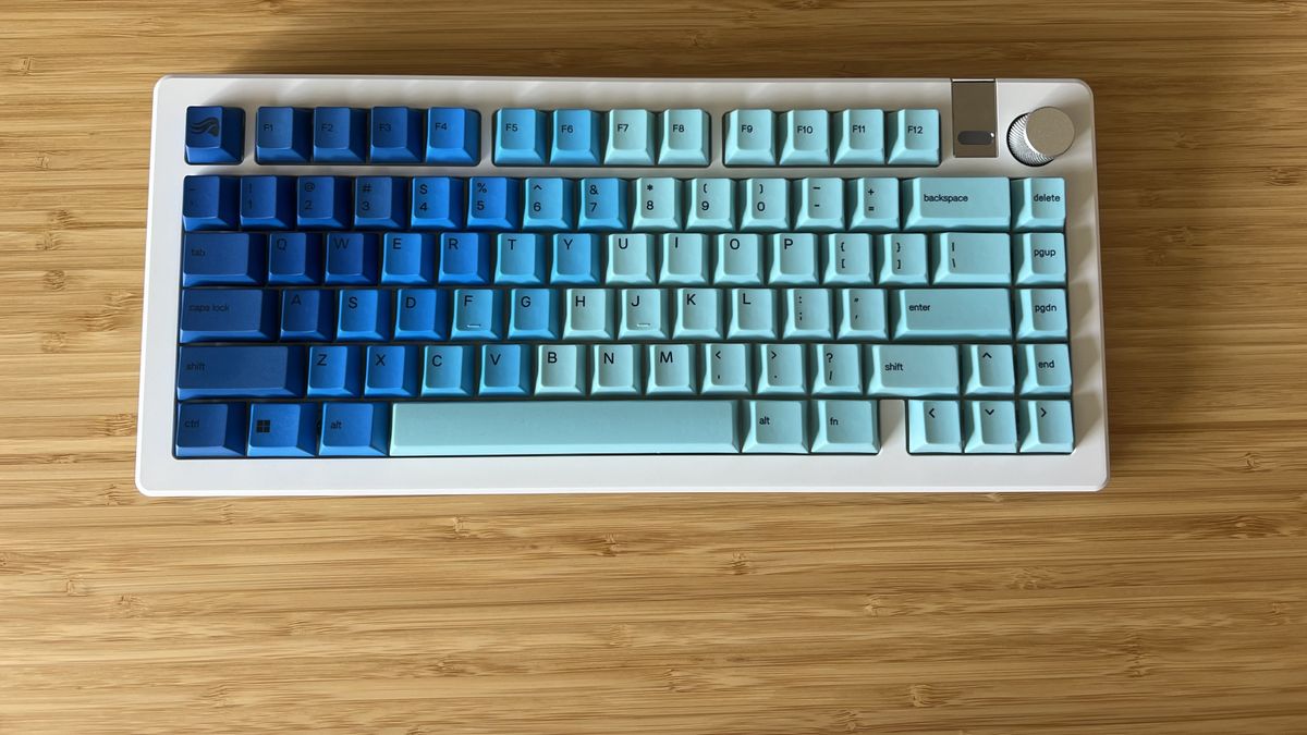 Glorious GMMK 3 keyboard in blue and white on a wooden gaming desk