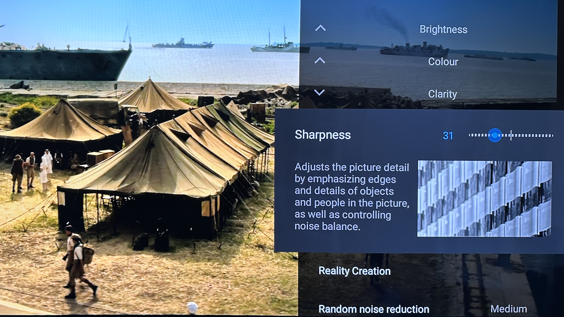 TV picture setting menu with image of tents in background