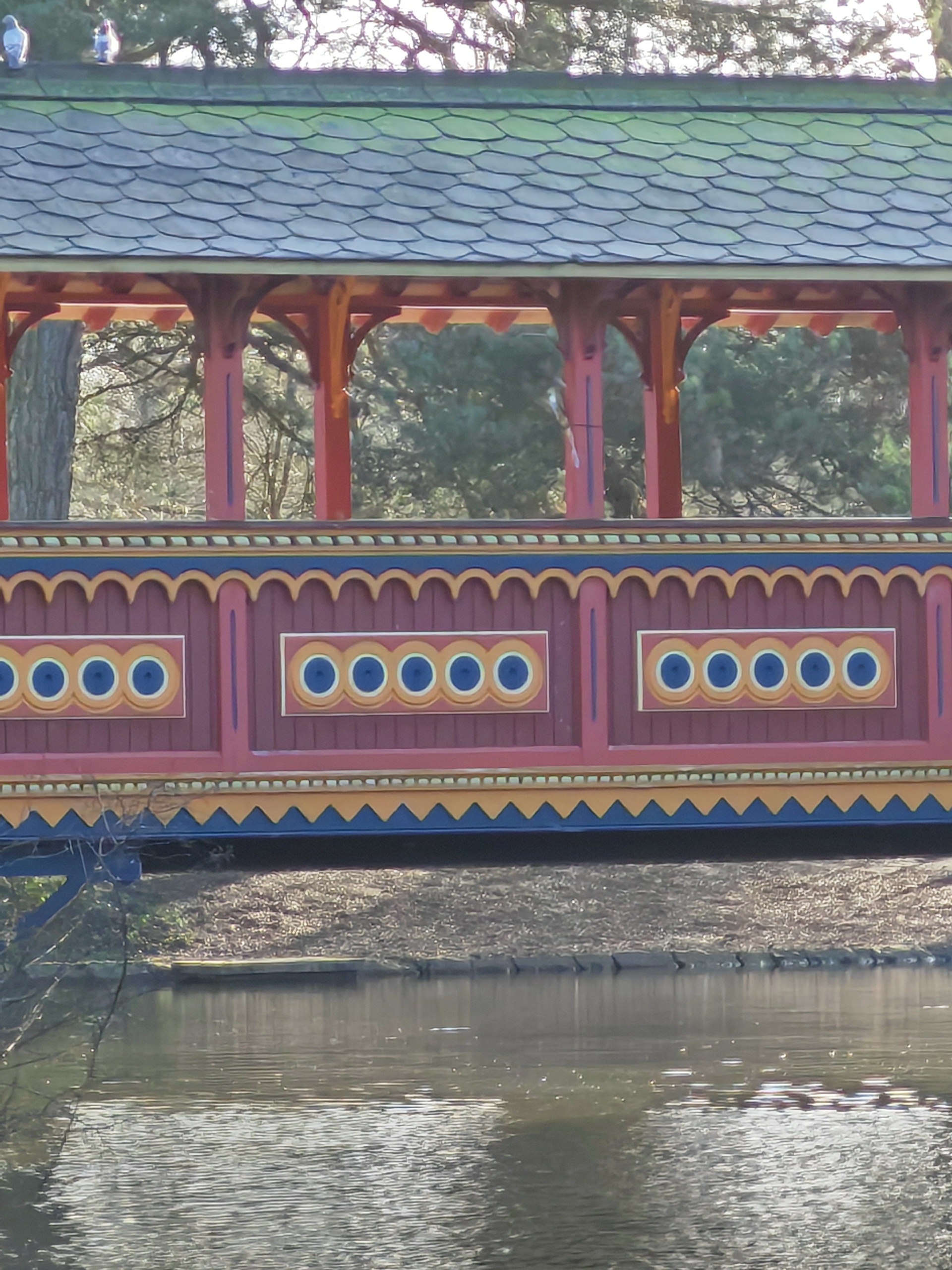 Honor Magic V2 sample photo showing wooden bridge over lake in wooded area at 10x zoom