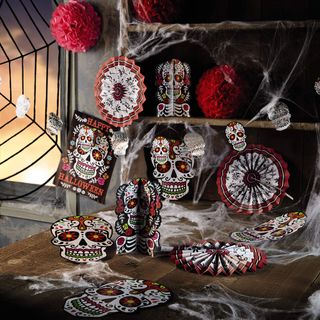 halloween decorative items with skeletal posters on wooden table