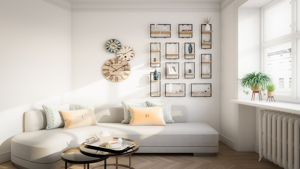 How to arrange furniture in a small living room like this with gray corner sofa, nesting coffee table, plants and gallery wall on neutral white wall paint