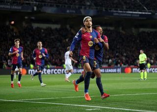 Ronald Araujo of FC Barcelona celebrates scoring his team's second goal with teammates Jules Kounde during the UEFA Champions League 2024/25 League Phase MD8 match between FC Barcelona and Atalanta BC at Estadi Olimpic Lluis Companys on January 29, 2025 in Barcelona, Spain.