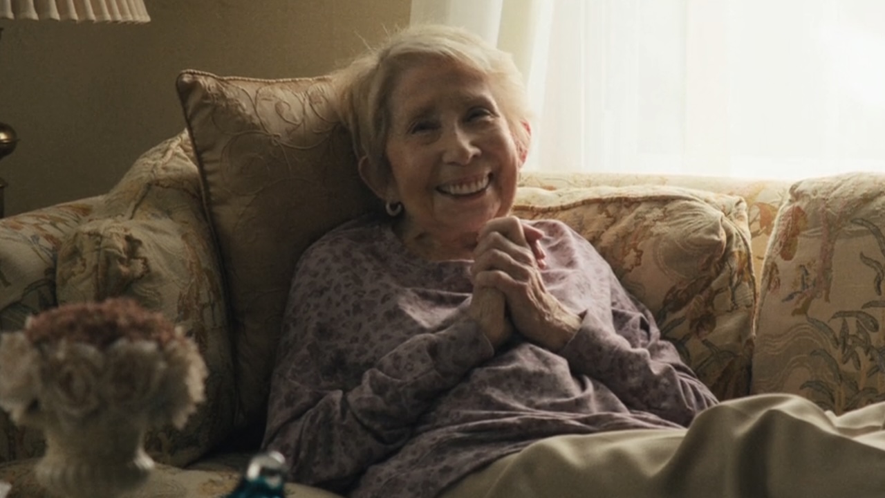 Teresa Bonaventura smiling with hands clasped in The Chair Company Season 1