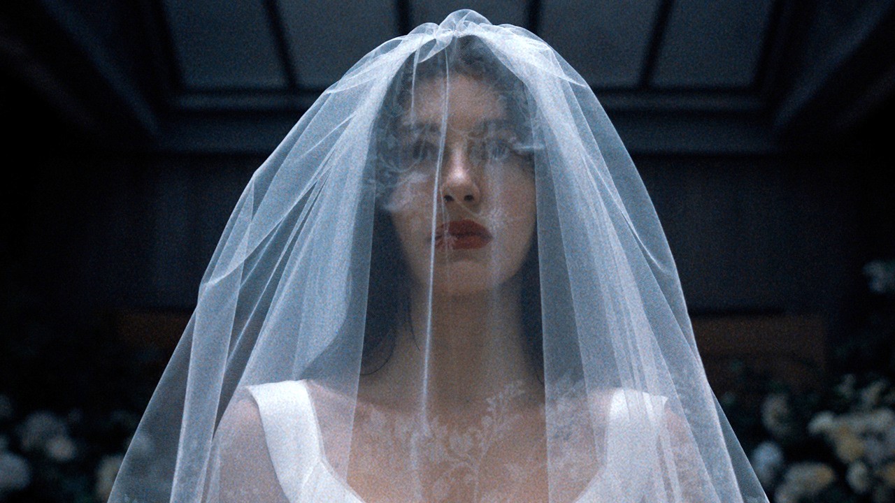 Camila Morrone is shown in a wedding dress as Rachel Harkin in Netflix's Something Very Bad Is Going to Happen.