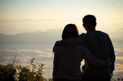 Silhouette of couple watching sunset talking about organ donation