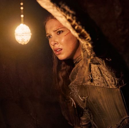 Millie Bobby Brown holds up a glowing orb in the netflix movie 'damsel'