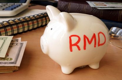 Piggy bank with word RMD. Retirement concept.