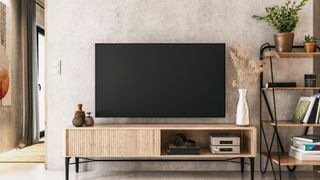 Living room with plaster-effect walls and wood furniture