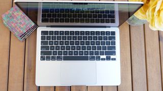 MacBook Air 13 M3 top down photo on a slatted table showing the full keyboard