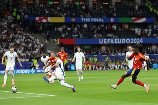 Nico Williams of Spain scores his team's first goal whilst under pressure from Kyle Walker of England during the UEFA EURO 2024 final match between Spain and England at Olympiastadion on July 14, 2024 in Berlin, Germany