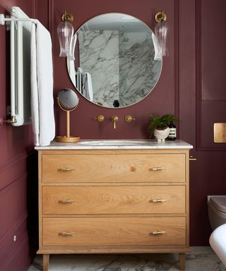 Bathroom mirror ideas with round mirror and red wall