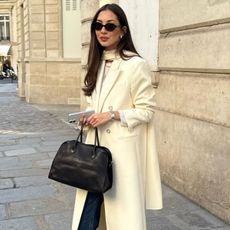 Brown-haired influencer wearing The Row Margaux bag