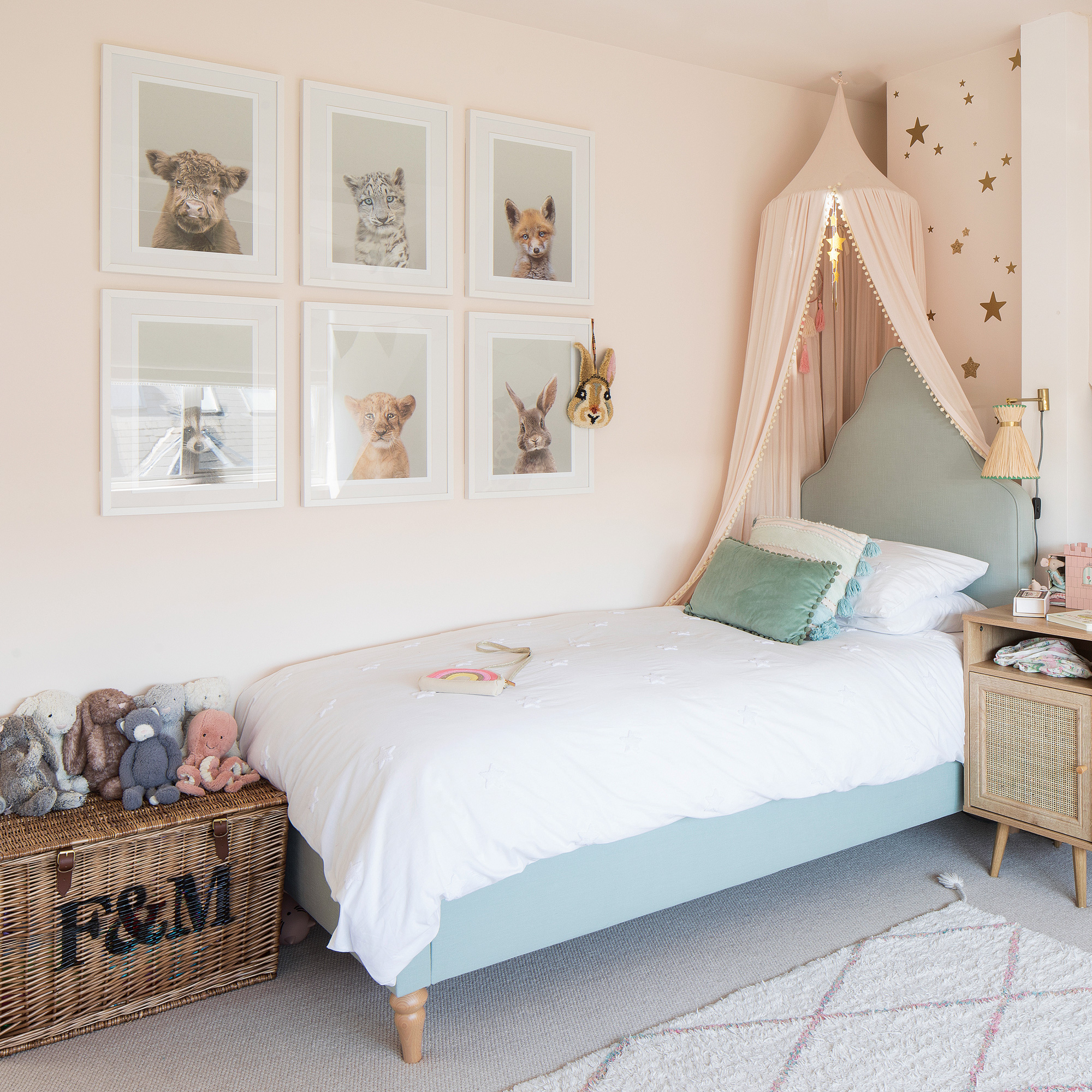 neutral kids room with canopy and pale green bed