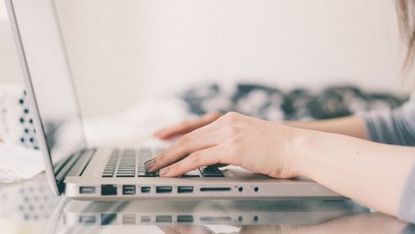 Woman typing on laptop