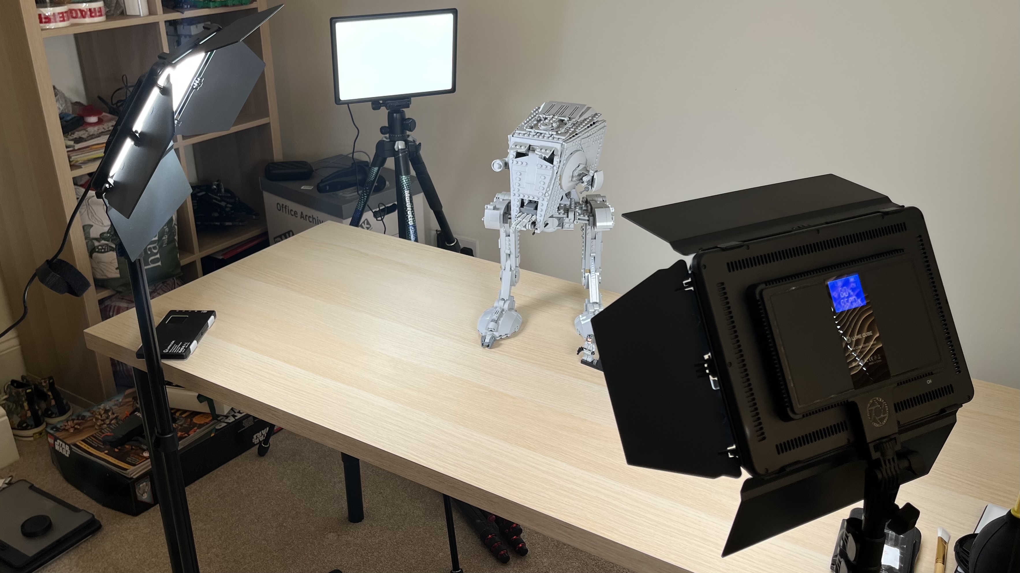 Lume Cube Studio Panel Lighting Kit with non-Lume Cube light panel in background with Lego kit on wooden table