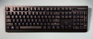 black full-size keyboard against light blue background
