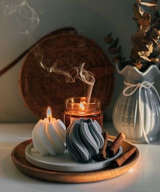 Three candles on a tray on a white table