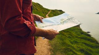 Woman holding map on route