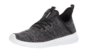 A pair of speckled black and white Adidas cross training shoes.