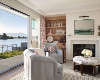 Traditional sunroom with upholstered furniture and view of the sea