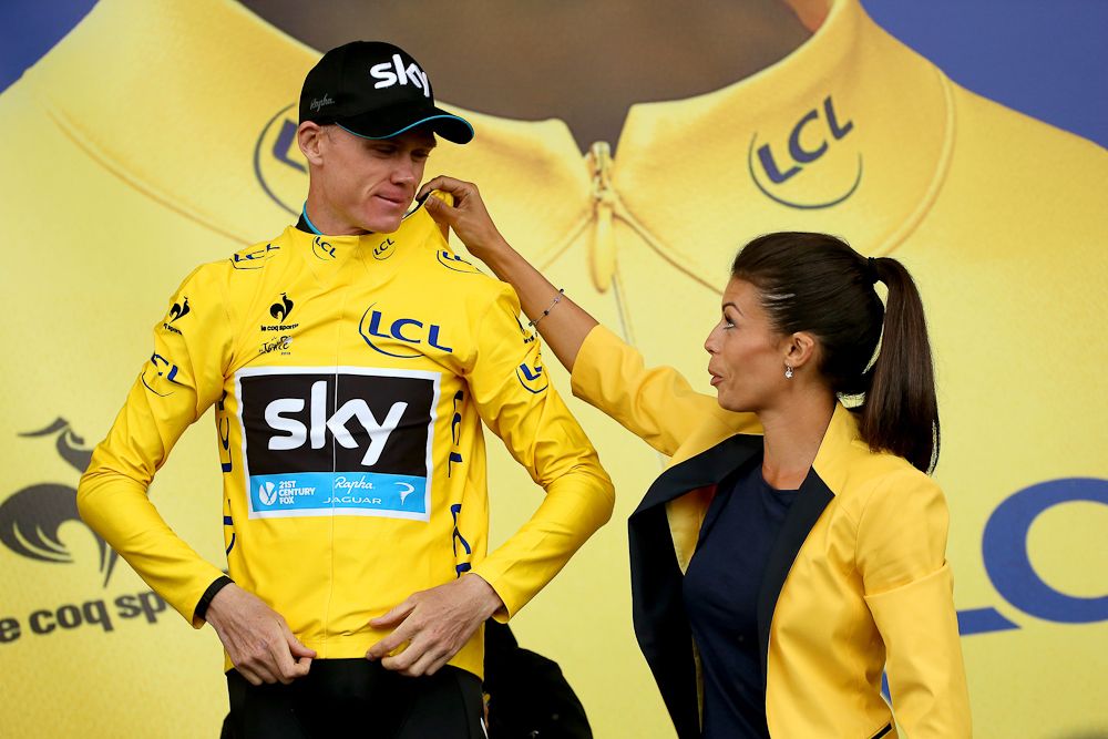 Chris Froome gets help with his yellow jersey.