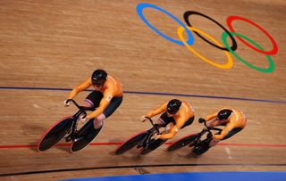 IZU JAPAN AUGUST 03 Roy van den Berg Harrie Lavreysen and Matthijs Buchli of Team Netherlands sprint to setting a new Olympic record ahead of Team Australia during the Mens team sprint qualifying of the Track Cycling on day eleven of the Tokyo 2020 Olympic Games at Izu Velodrome on August 03 2021 in Izu Japan Photo by Tim de WaeleGetty Images