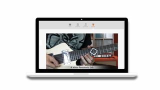 Orange Learn review: Laptop screen showing video of person playing guitar