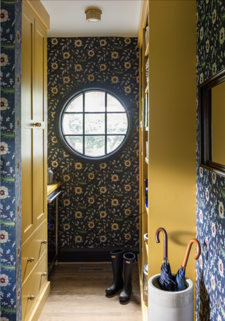 Blue and yellow boot room with bold wallpaper