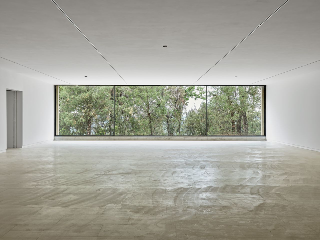 long vertical window looking out at the landscape at Fondation Maeght in France