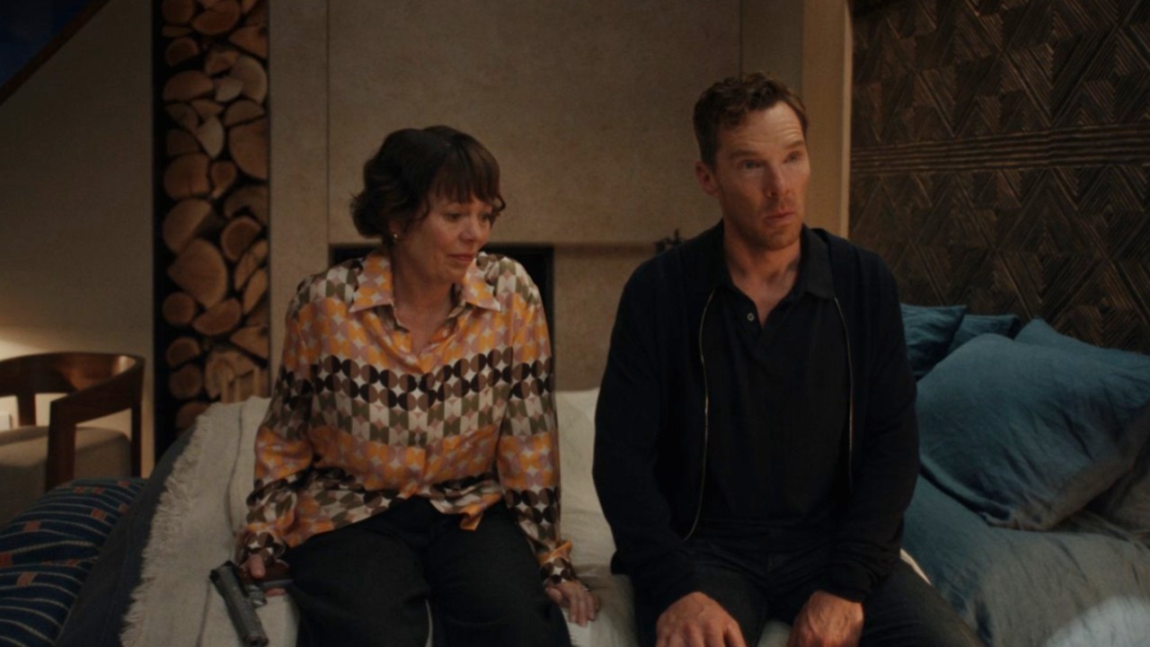 Olivia Colman and Benedict Cumberbatch sitting on a bed in The Roses.